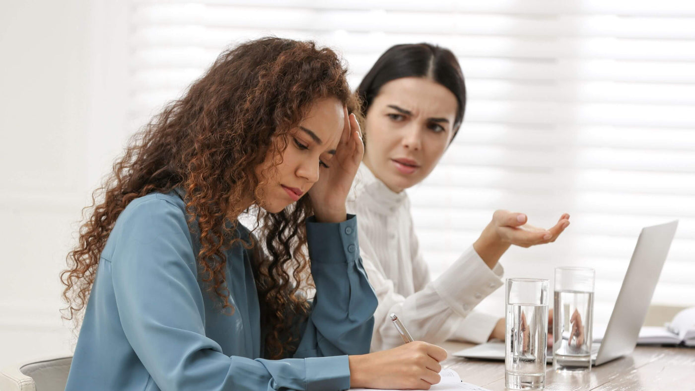 female co-workers discussing racist harassment
