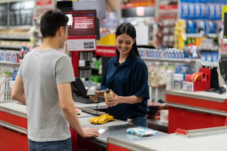 grocery cashier serving customer