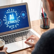 User of laptop with 'AI Ethics' on the screen