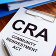 Paperwork with 'CRA Community Reinvestment Act' text.