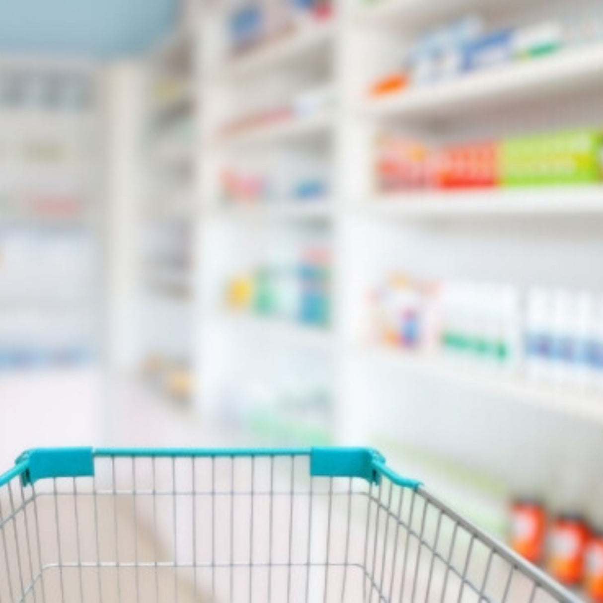 A shopping cart in a pharmacy aisle