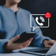Person using a smartphone with a call red warning icon overlay