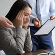 Person in a business setting with another person holding a tablet