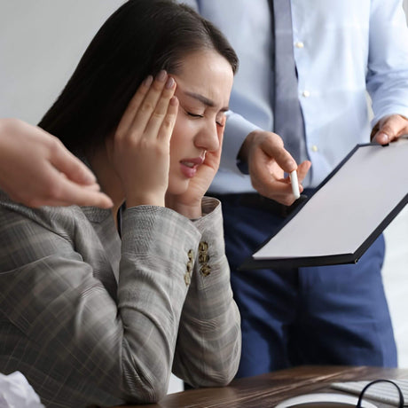 Person in a business setting with another person holding a tablet
