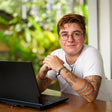 transgender man with laptop in California office
