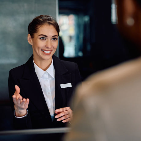 Happy female receptionist serving a guest